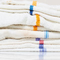 How are kitchen towels cleaned?